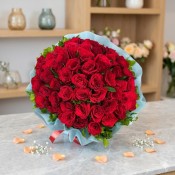 Red Rose Bouquet in Sky Blue Paper Packing with Greens