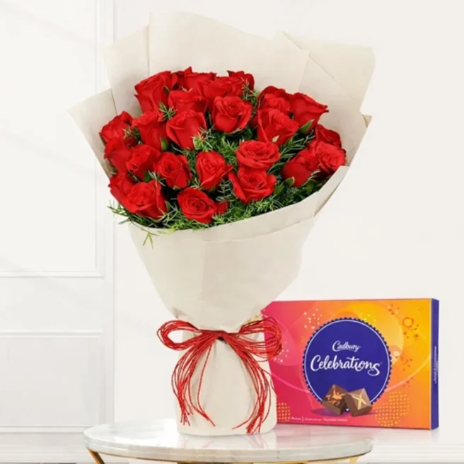 red roses bouquet with off white paper packing and Cadbury Celebrations box